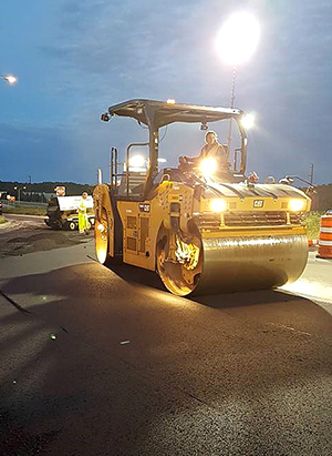 Crew paving roadway.